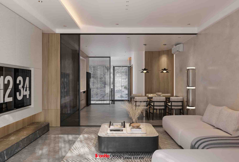 Thiết kế nội thất Vinhomes Vũ Yên Hải Phòng - Giải pháp không gian linh hoạt cho biệt thự 3 tầng 53 Phòng khách được ngăn với khu bếp bằng hệ cửa kính khung mảnh, vừa đảm bảo tính kết nối vừa hạn chế mùi khi nấu ăn